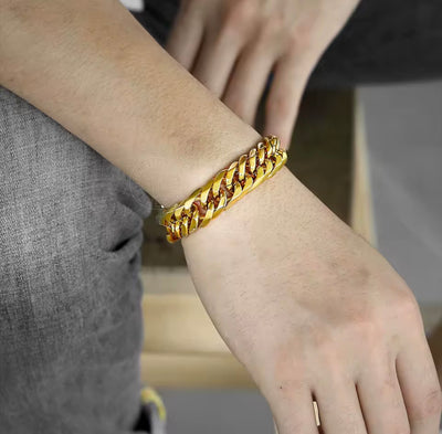 Gold Cuban link bracelet worn on wrist